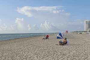 People Sunbathing in South Beach Miami.